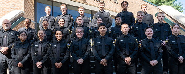 ‘The Appalachian Police Academy’s seventh class is pictured with App State Police Capt. K.C. Mitchell, far left in the second row, and App State Police Master Police Officer Cashae Cook, second from left in the second row, on the steps of App State’s Rosen Concert Hall