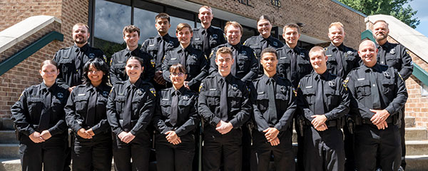 ‘Graduates of the Appalachian Police Academy’s eighth class are pictured on the steps of App State’s Rosen Concert Hall, with Director of Police Development Cameron Masin ’20, far left in the second row, Director of Public Safety and Chief of Police Johnny Brown, far right in the first row, and Appalachian Police Department Sgt. Jim Robertson, far right in the second row. 